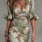 Anne | Long, asymmetrical green satin dress with a V-neck, puff sleeves, and a floral print