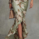 Anne | Long, asymmetrical green satin dress with a V-neck, puff sleeves, and a floral print
