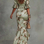 Anne | Long, asymmetrical green satin dress with a V-neck, puff sleeves, and a floral print