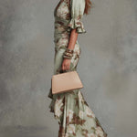 Anne | Long, asymmetrical green satin dress with a V-neck, puff sleeves, and a floral print